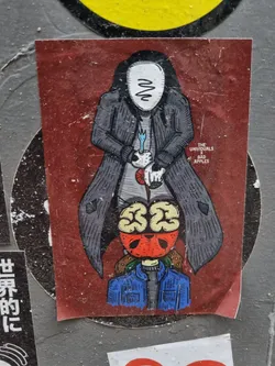 Sticker featuring an illustration of a faceless figure in a long coat standing over a person with a brain for a head. The style is dark and graphic, with a color scheme of dark grays, reds and blues. 