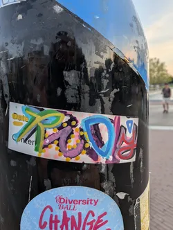 Street sticker A rectangular white sticker featuring hand-drawn graffiti letters spelling 'RUDY!' in vibrant green, yellow, purple, blue, and red markers. Faint printed template text 'Date' and 'Content' is visible underneath.