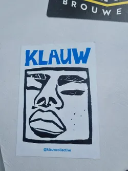 Street sticker A sticker featuring a stylized black and white illustration of a face. The word KLAUW is written in blue at the top.  The artist's Instagram handle is included at the bottom.