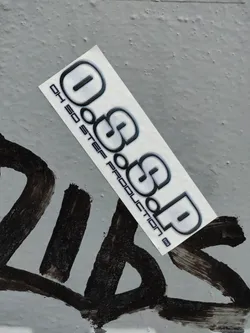 Street sticker A sleek, gray and black sticker featuring the logo "OGSOP" with the text "01 SO STEP Production" underneath.  The sticker has a modern, minimalist design.