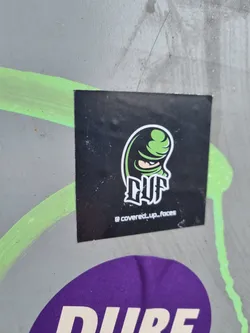 Black and green sticker featuring a stylized masked figure and the logo "CUF". The Instagram handle @covered_up_faces is visible at the bottom. 