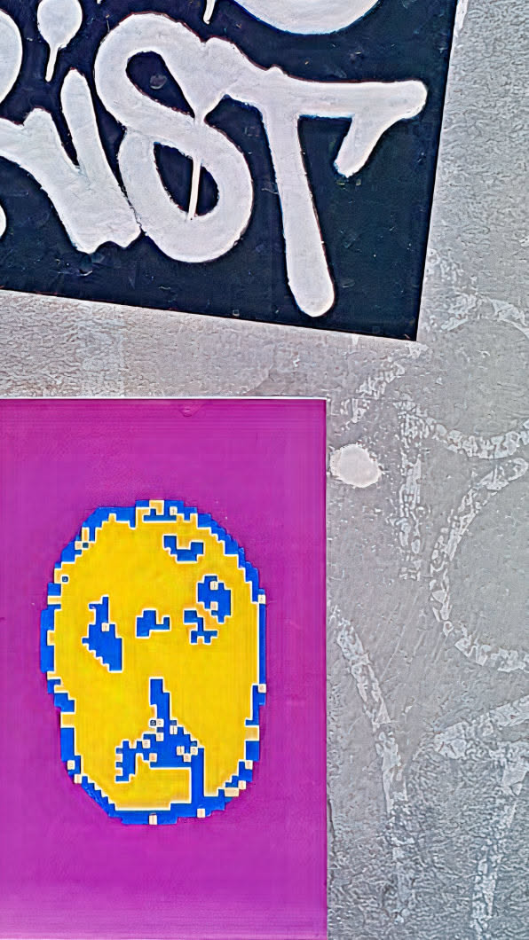 A striking sticker featuring a pixelated yellow skull with blue accents, set against a bold purple background. The style is reminiscent of early video game graphics, giving it a retro feel.