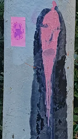 A pink sticker featuring a pixelated figure on a pole, accompanied by a drawing that looks like paint dripping.