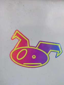A sticker of a stylized cartoon creature with a gradient of purple and pink colors.  The outline is a neon yellow-green. 