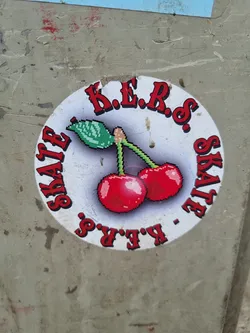 Street sticker Round sticker with pixel art of two cherries and text in a circle. The text says K.E.R.S. SKATE K.E.R.S..