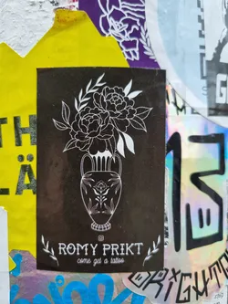 Street sticker Black and white sticker featuring a line art drawing of peonies in a vase.  The sticker advertises tattoo services by the artist Romy Prikt.