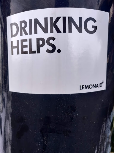 Street sticker Amsterdam DRINKING HELPS. LEMONAID