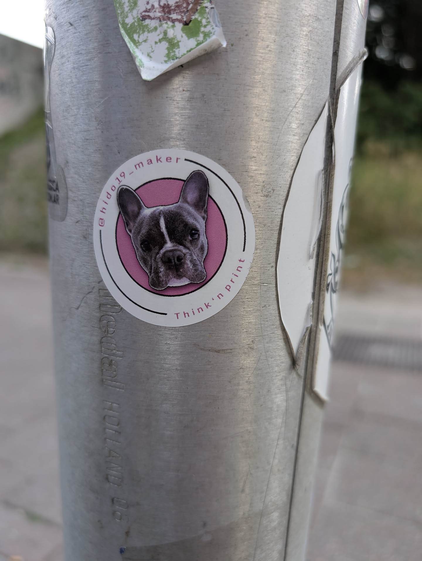 A round sticker depicting a French Bulldog head inside a pink circle, bordered by white with text.