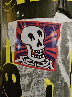 Street sticker A sticker featuring a cartoon skeleton with a sunburst background. The text "FromTheWrd" is visible in the top right corner.