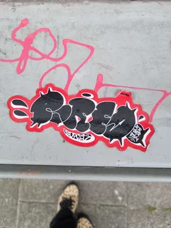 Black and red graffiti sticker with stylized lettering. The sticker has a somewhat aggressive design with spikes around the lettering.  The main text appears to say 'RUFED'. There are no visible social media links or QR codes.