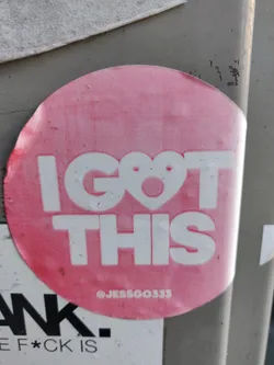 Street sticker Pink round sticker with the text "I GOT THIS" in bold white uppercase letters. A small heart is in place of the letter "O". The text "@JESSGOO333" is visible at the bottom of the sticker. 