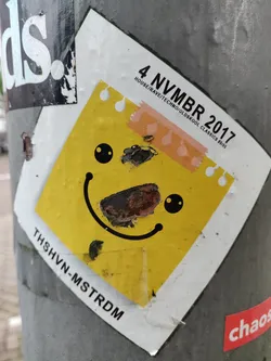 Street sticker A yellow square sticker with a simple cartoon happy face. The text on the sticker indicates it's from a House/ Rave/ Techno/Oldskool Classics event that took place on November 4th, 2017. The sticker shows some signs of wear and tear.