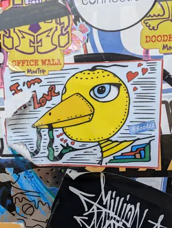 Street sticker Yellow bird sticker with hearts and the text "I'm Love".  The artist's Instagram handle is included (@Boodzz).