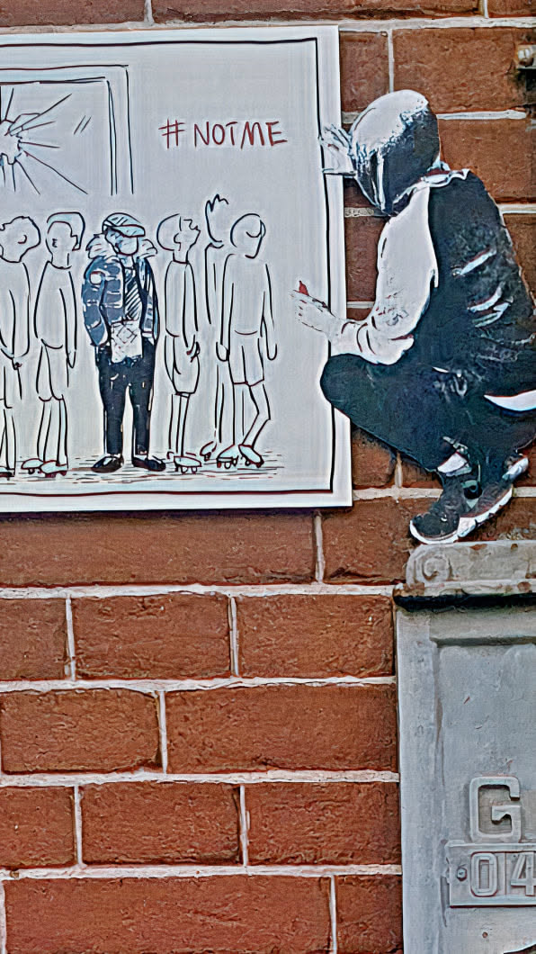The sticker portrays a poignant scene: a row of similar-looking figures, with one figure standing out in a distinct outfit. They stand before a window that appears to be shattered, hinting at exclusion or escape. The graffiti-like tag '#NOTME' underscores the theme of individuality or dissent. Beside it, there is another sticker of a person painting the wall. The artwork is placed against a textured brick wall, adding an urban feel.