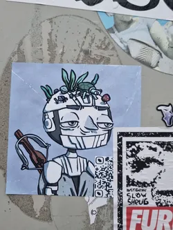 A sticker featuring an illustrated character with plants, a turtle, and a mushroom on its head. The character is holding a crossbow and has a relaxed expression. The art style is cartoonish with muted colors.