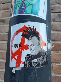 Street sticker A sticker featuring a portrait of a punk rocker with a mohawk, set against a red anarchy symbol. The text "Who else" is partially visible on the left side, while "PUNK" is prominently displayed in bold letters.