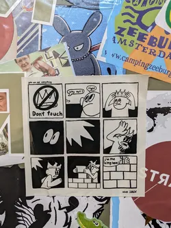 A black and white comic strip sticker features a king building a wall. The text on the sticker includes "You can see everything", "Don't touch", "Why not?", "Right", and "I'm the king here". The artist's signature is "2023 DREW".