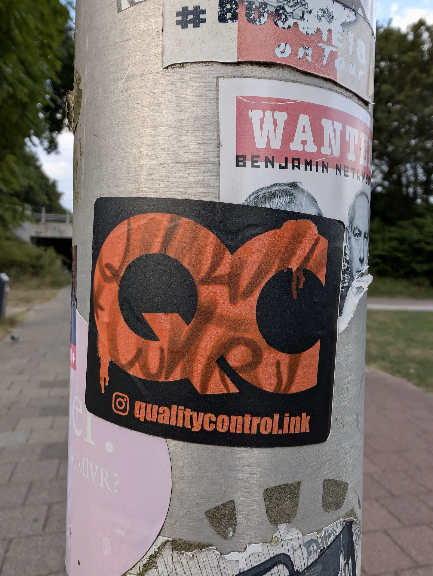 A rectangular black sticker featuring stylized orange 'QC' letters filled with graffiti tags. Below, an Instagram handle 'qualitycontrol.ink' is displayed.