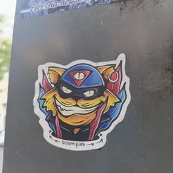 Street sticker A sticker featuring a cartoon illustration of a cat wearing a mask resembling a SWAT officer's helmet. The cat has a mischievous grin and three eyes.  The sticker also includes the text "@ciem.pies" at the bottom and "SWATCATS" in the helmet.