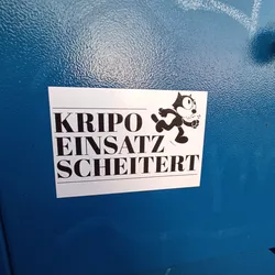 Street sticker A sticker featuring a cartoon cat running and the text "Kripo Einsatz scheitert" (Criminal Police Operation Fails) in German. The design is simple, with black text and the cat illustration on a white background.