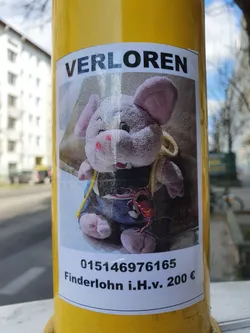 Street sticker A lost stuffed pig is shown in this lost and found poster.  The poster includes a phone number and a reward amount.