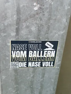A black and yellow sticker with a text that says: "Nase voll vom Ballern. Die Nase voll." and a QR code.  There is also a small graphic of a razor blade and a pile of something, possibly representing ammunition or drugs. The top right corner shows an Instagram handle.