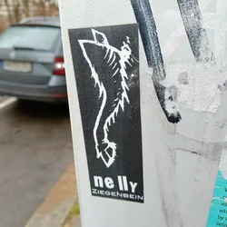 Black and white sticker with a stylized graphic of a leg and foot. The artist's name, nelly ZIEGENBEIN, is printed at the bottom.