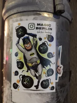 Street sticker A sticker featuring a cartoon depiction of Batman holding bombs, with the text 'MAGIC BERLIN' and 'We love bombing'.  There is an Instagram logo present.