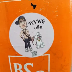 Street sticker A sticker featuring a cartoon illustration of a man with tattoos, wearing a cap and holding a leash attached to a poodle. The man is smoking. The text 'DAWG 080' is prominently displayed.