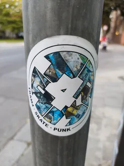 Street sticker Round sticker featuring the number 4 stylized with collage-like imagery. The text 'Tram4 - Skate - Punk' is visible around the central design. The style is reminiscent of skateboarding and punk culture.