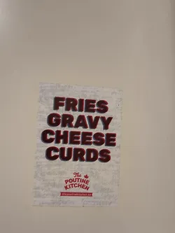 Street sticker The sticker is a rectangular, vertically oriented design with a light, textured background that resembles distressed paper or a subtle pattern. Dominating the upper two-thirds are the words "FRIES GRAVY CHEESE CURDS" stacked vertically in large, bold, blocky letters. The letters are primarily a deep red color with a dark blue or purple shadow effect, giving them a 3D appearance. Below this text, centered towards the bottom, is a logo that reads "The POUTINE KITCHEN". "The" is smaller and above "POUTINE KITCHEN", which is in a stylized red font. A small red maple leaf icon is positioned above the "I" in "POUTINE". Beneath the logo, a red banner contains the website address "thepoutinekitchen.de" in white text.