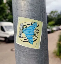 A sticker featuring the words 'Second Hand Vintage' in a stylized graffiti font. The design is predominantly blue and yellow, with a unique logo or graphic element incorporated into the text.