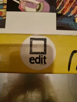 Street sticker Round white sticker with a black square and the word 'edit' written below it.  The website www.editart.com is visible at the bottom.