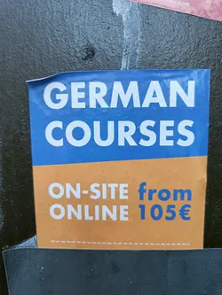Street sticker A flyer advertising German courses.  Both on-site and online options are available, starting from 105 euros.