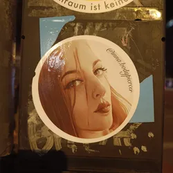 Street sticker Round sticker featuring a stylized illustration of a woman with long brown hair.  The art style is slightly painterly, with visible brushstrokes. The woman is looking off to the side with a subtle, pensive expression. The sticker includes the Instagram handle @inna.bodypiercer.