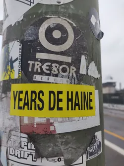 Street sticker A yellow sticker with the text "YEARS DE HAINE" over a round Tresor Berlin sticker. The Tresor sticker features its logo and the text "Tresor Berlin".