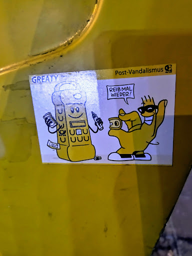 Street sticker A sticker featuring cartoonish illustration with a yellow telephone character holding money and a pen with a smiling face, standing next to a hand character wearing sunglasses and holding a coin. Text "REIB MAL WIEDER!" appears in a speech bubble above the hand character. The sticker is attributed to "Post-Vandalismus".