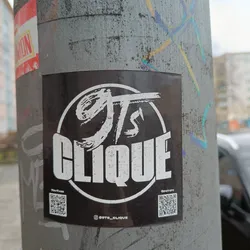 Street sticker A black and white circular sticker with the logo "GTS" and the word "CLIQUE" underneath. The sticker also contains two QR codes linking to Spotify and YouTube, as well as an Instagram handle.