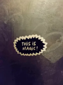Street sticker A sticker with a speech bubble shape, with the text "This is magic!" in a retro comic style. It is white with black text and a jagged edge.