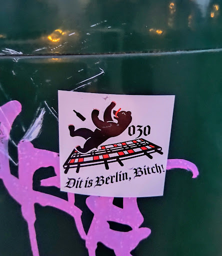 A sticker featuring a cartoon bear falling on a grid with the text 'Dit is Berlin, Bitch!' and the number 030, likely referring to Berlin's area code. The style is edgy and humorous.