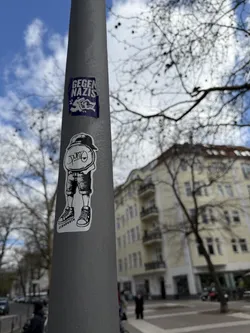 A black and white graphic sticker depicting a stylized character. The character features a disproportionately large, round head with a backward baseball cap, and a small body. The word 'Punto' is written across the character's face in a bold, stylized font. The body is dressed in baggy shorts and classic lace-up sneakers. The entire illustration is rendered in a clean line art style with solid black fills against a white background, cut out around its irregular shape.