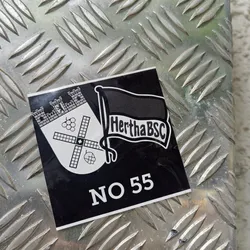 Street sticker Black and white sticker featuring the Hertha BSC logo and the number 55. The logo includes a coat of arms with a windmill and grapes, and a flag with the club's name.  The sticker is affixed to a metal surface.