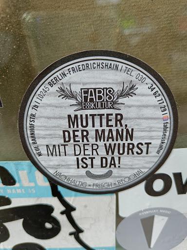 Street sticker I TEL. BERLIN-FRIEDRICHSHAIN 030 34 FABIS 62 10245 77 ESSKULTUR 29 7b MUTTER, - DER MANN BAHNHOFSTR. NEUE MIT DER WURST &Oacute; IST DA! LL NACHHALTIG x FRISCH x REGIONAL Y NAME IS OV @VERFLIXT MUSIC