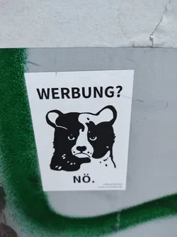 Street sticker A black and white sticker featuring a bear-like creature with a grumpy expression.  The text on the sticker says "WERBUNG?" (Advertising?) and "NÖ." (No.)