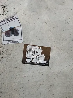 Street sticker A brown square sticker with white text and graphics. The text includes the magazine's name and a tagline. The style is abstract and modern.