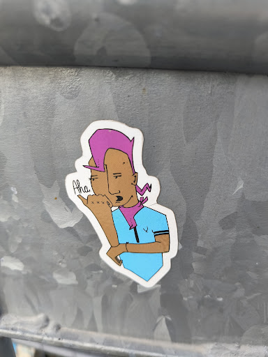 Street sticker This sticker features a cartoon-like illustration of a person with pink hair, a purple bandana, and a light blue shirt. The character has a playful expression and appears to be making a gesture. The art style is simple yet expressive. The sticker is affixed to a metallic surface.