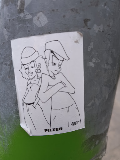 A white sticker with a black line drawing of a cool couple with the word "FILTER" at the bottom left. The drawing has a distinctive, retro style, with the woman in a strapless top and a hat, and the man with crossed arms and a similar hat.