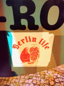 Street sticker A sticker featuring a grim reaper grilling a kebab.  The text 'Berlin life' is prominently displayed. The sticker has a website address at the bottom.