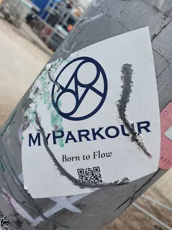 Street sticker A sticker featuring a logo of three interconnected circles and the text 'MYPARKOUR' and 'Born to Flow'.  It includes a QR code at the bottom. The sticker is partially damaged around the edges.