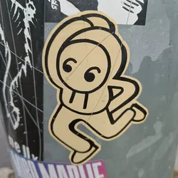 Street sticker This sticker features a simple, cartoonish figure in a dancing pose. The figure is primarily yellow with black outlines, giving it a retro feel. The style is reminiscent of simple line drawings or doodles.